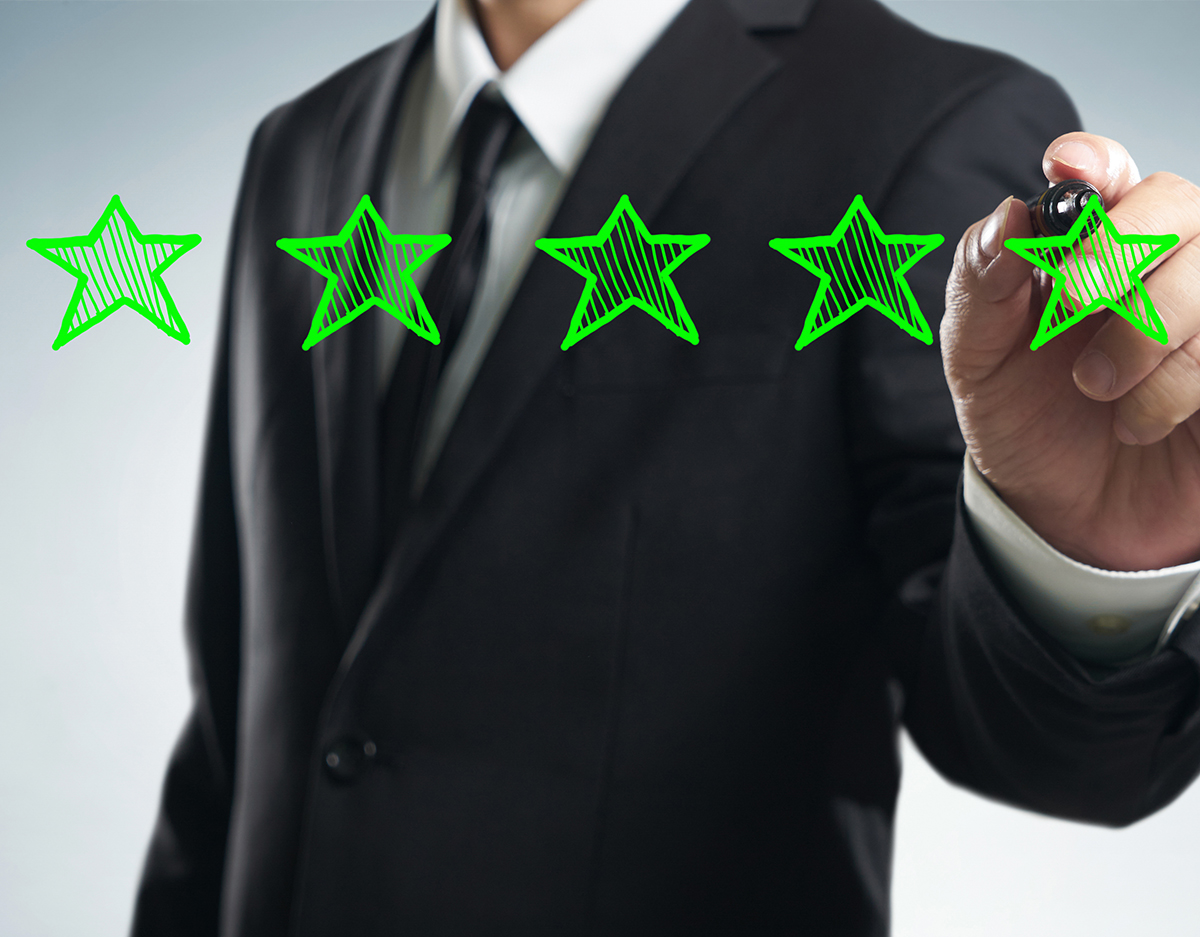 Review, increase rating, performance and classification concept. Businessman draw five green stars to increase rating of his company, blank background.